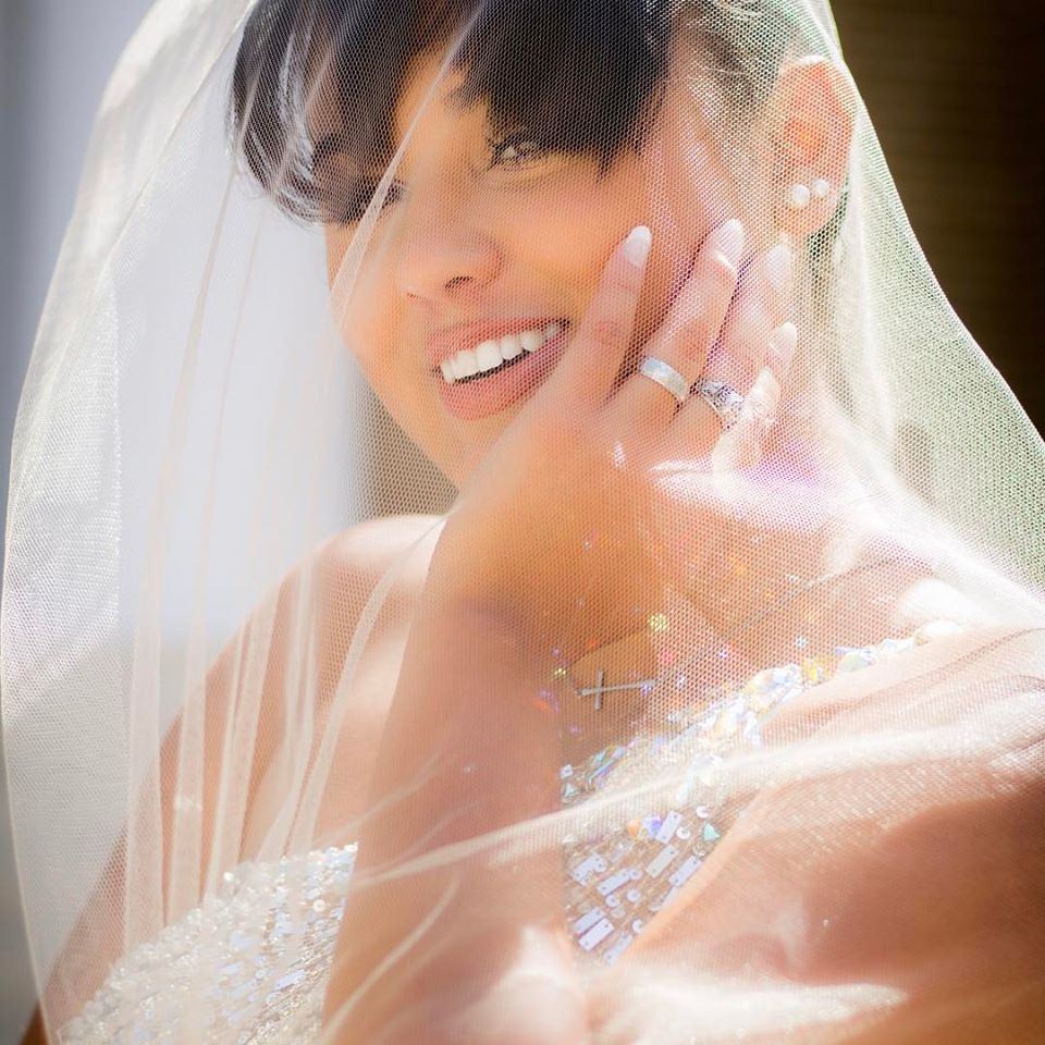 Under the veil: Light, lace and a joyful bride.