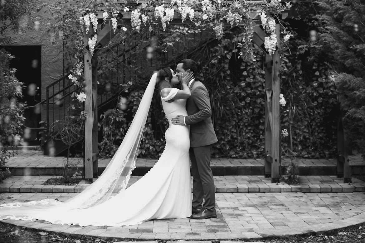 The first kiss: A garden ceremony under the wisteria.